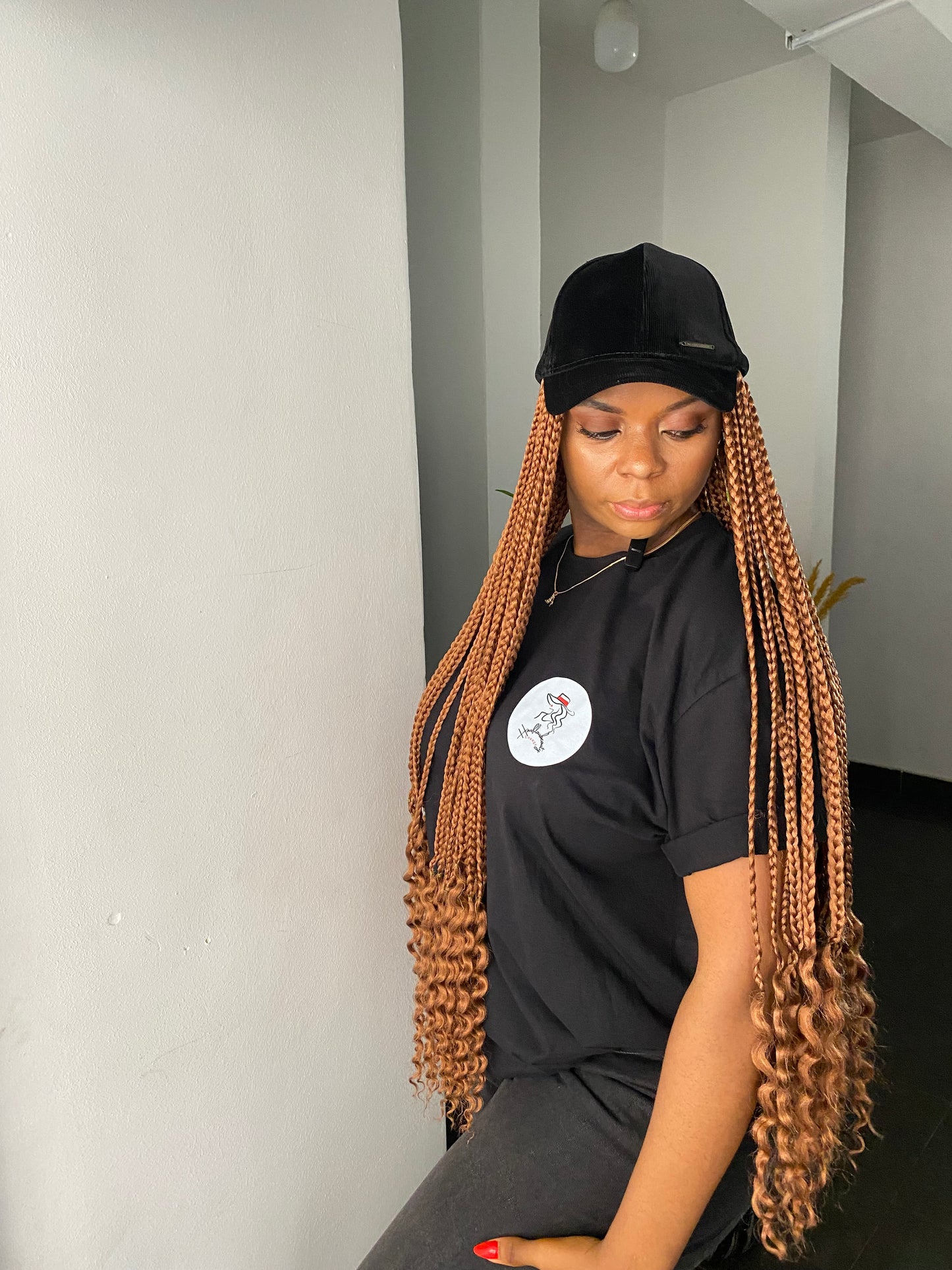 Brown braids in black face cap