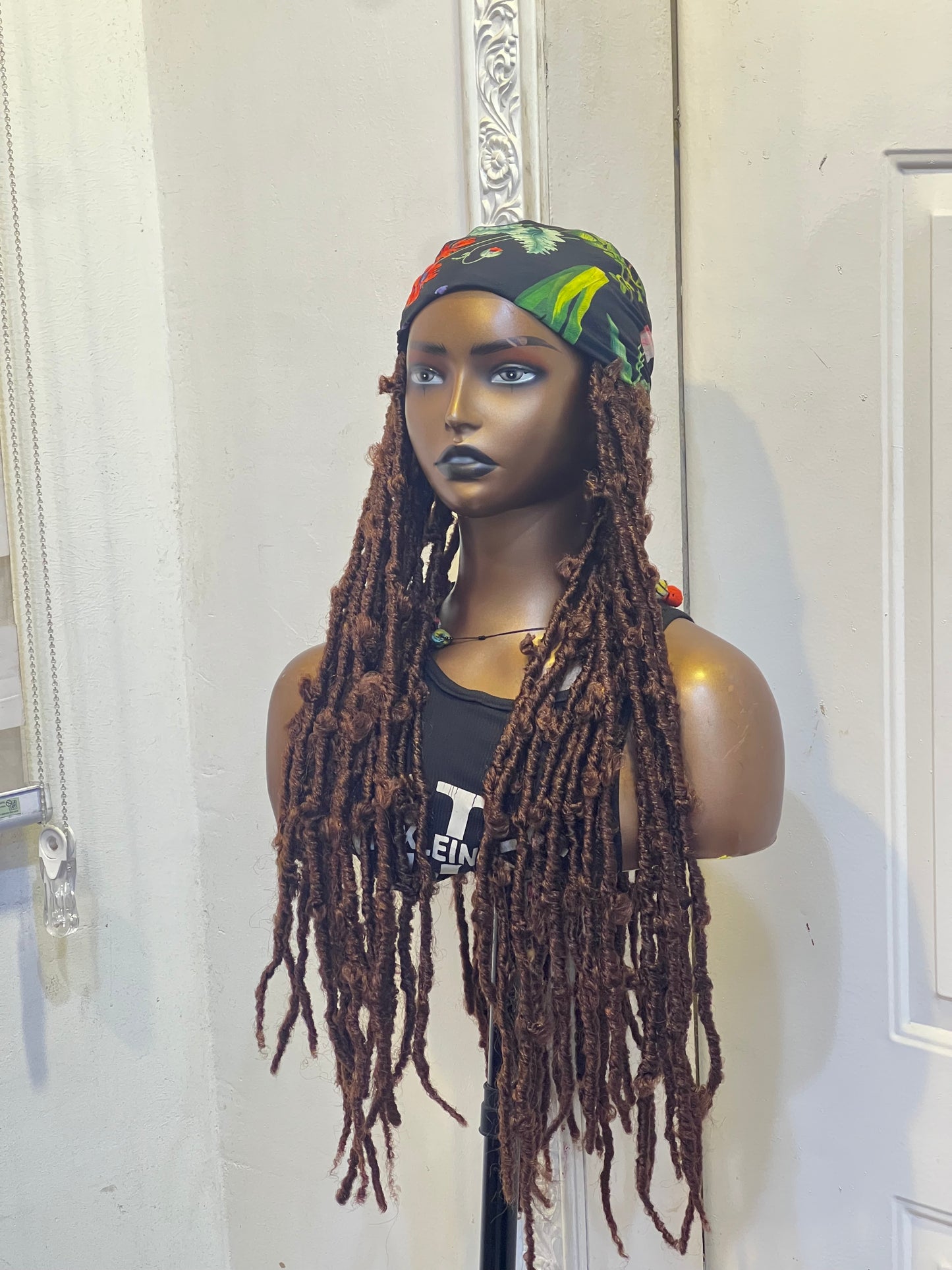 Brown butterfly locs on flowery scarf
