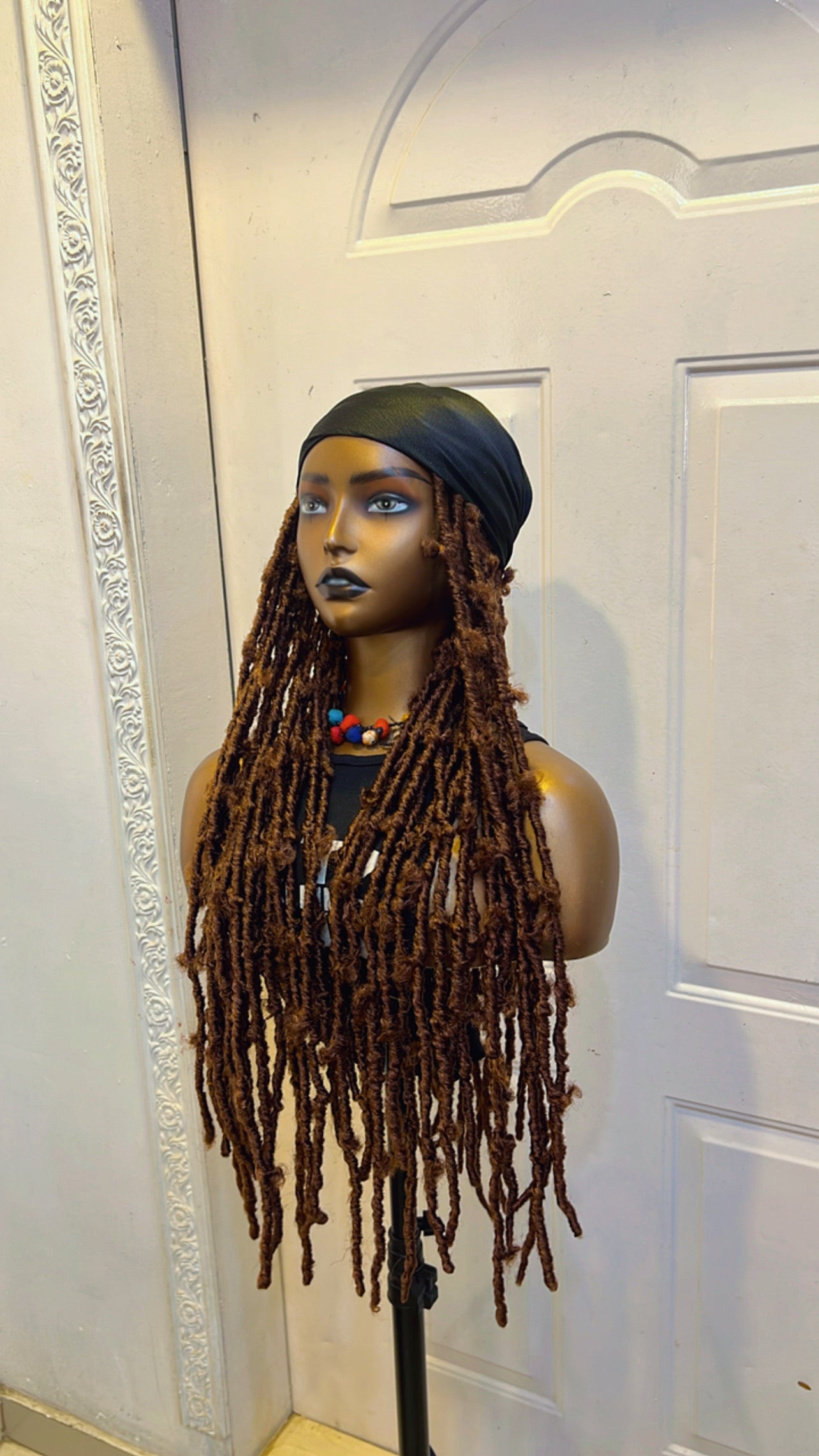 Brown butterfly locs in black scarf