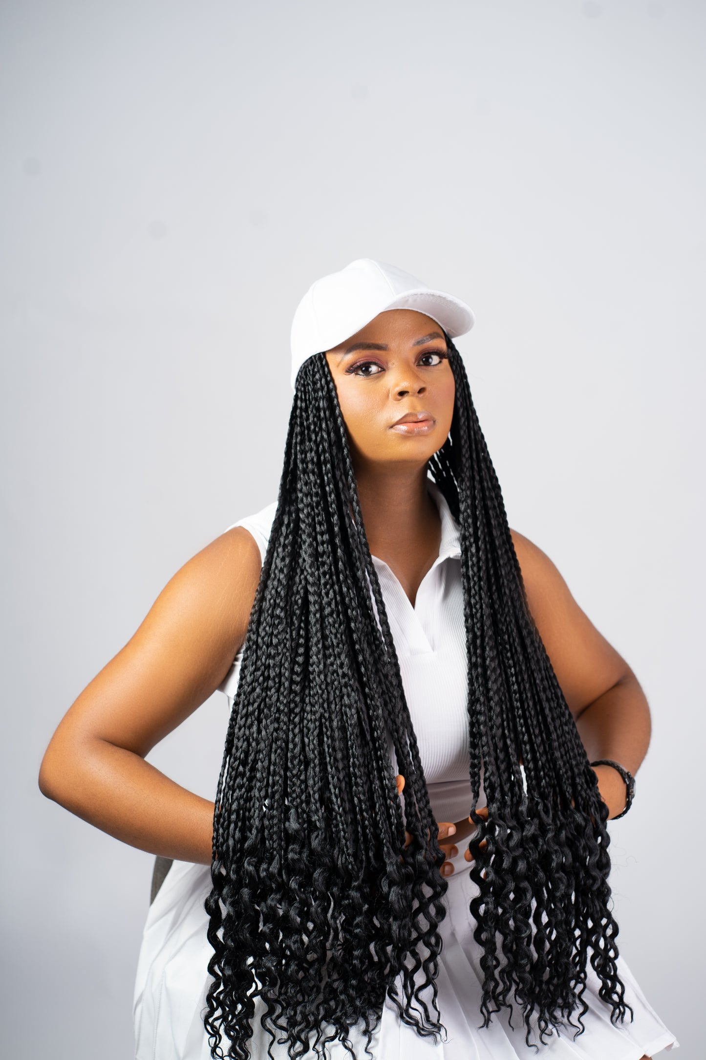 Black braids on white cap