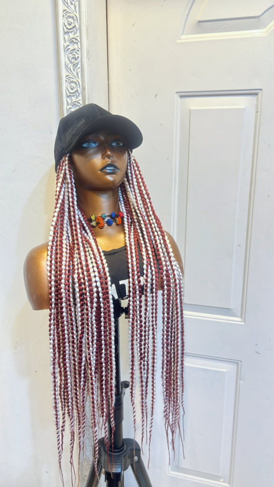 Bold color French braids in black cap