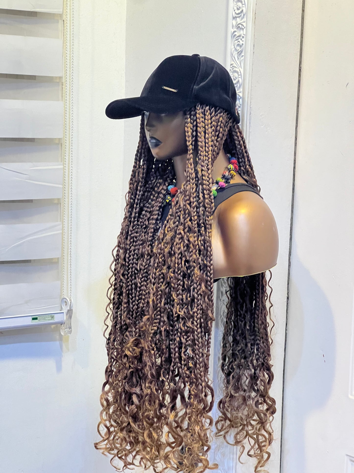 Brown boho braids on black cap