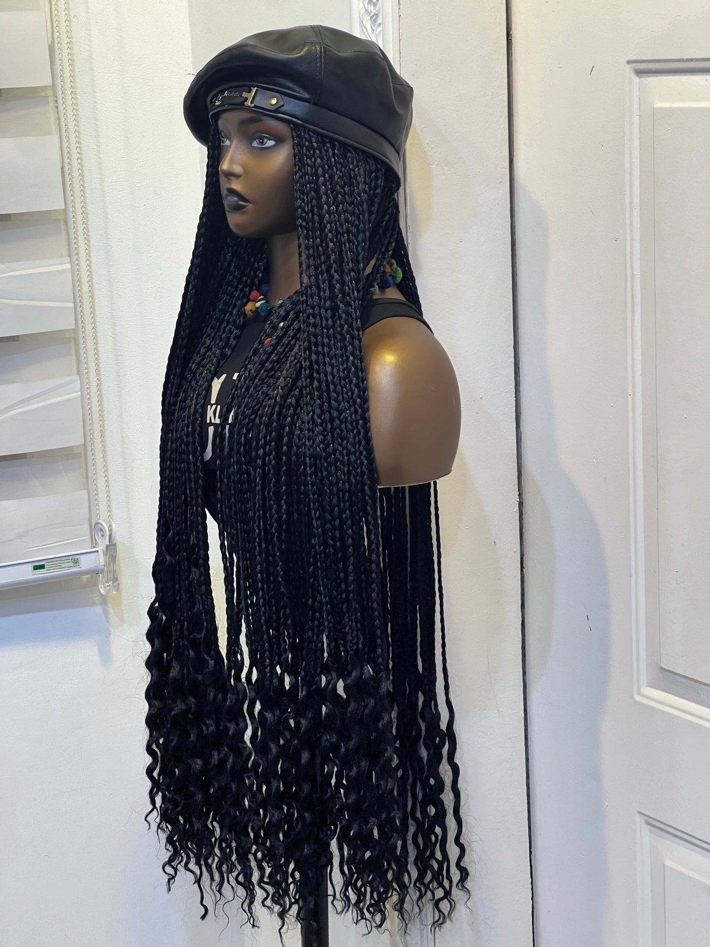 Black braids on black beret