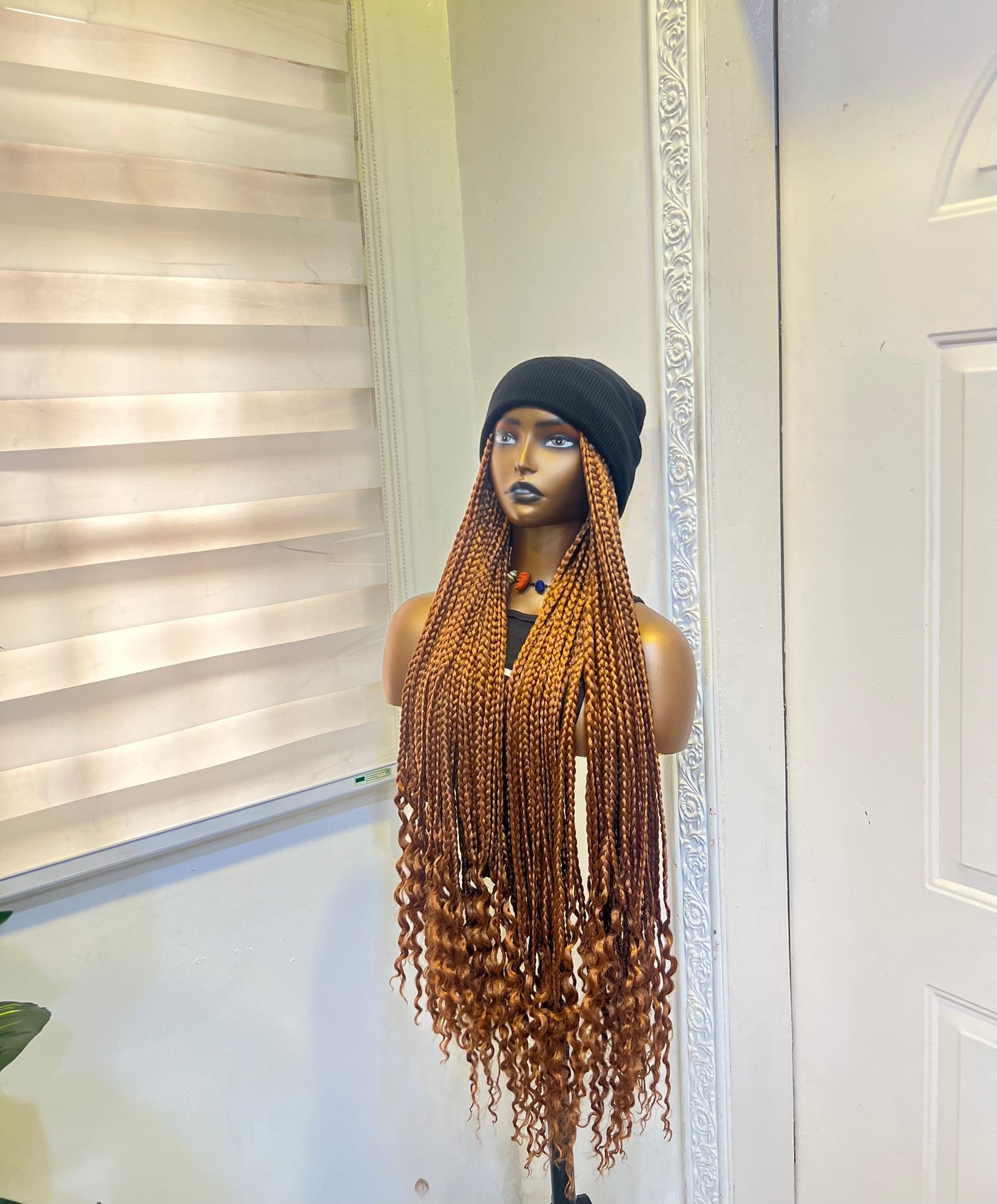 Brown braids on black beanie