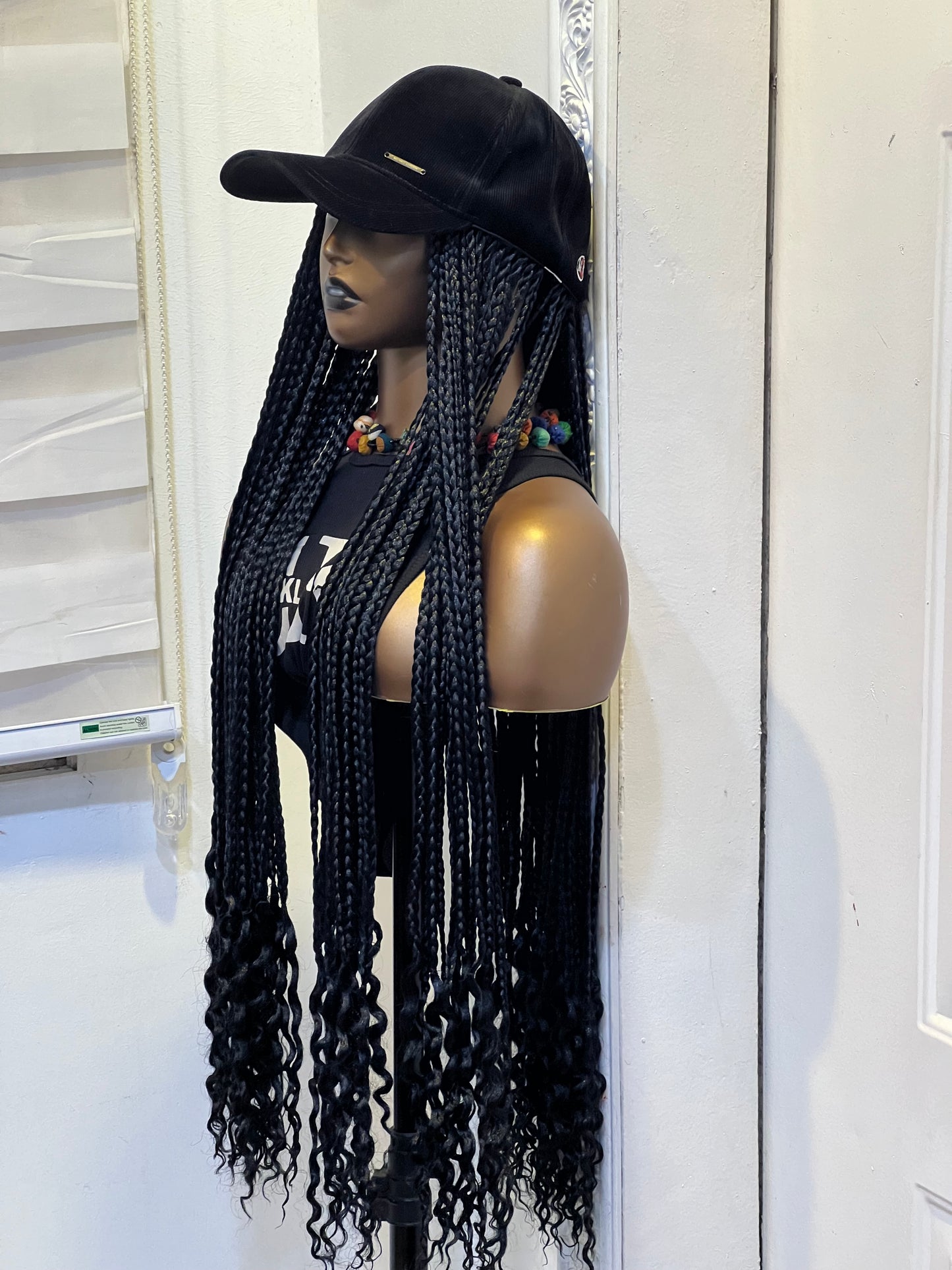 Black braids on black cap