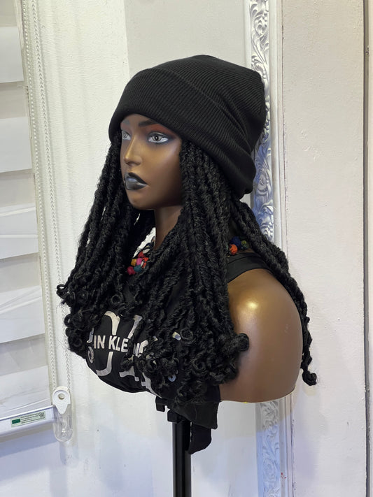 Short black dreads on black beanie