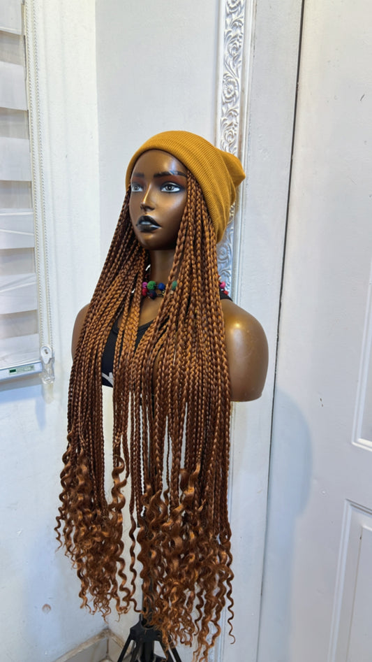 Brown braids in gold beanie
