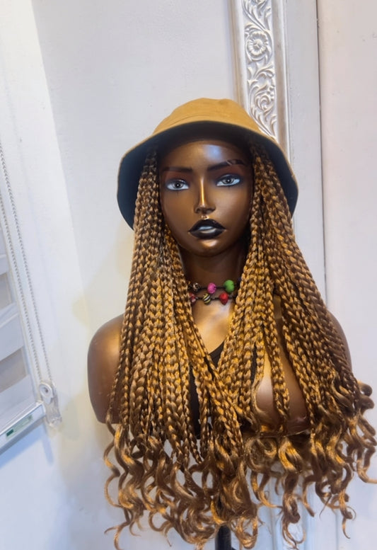 Carton bucket hat on golden brown box braids
